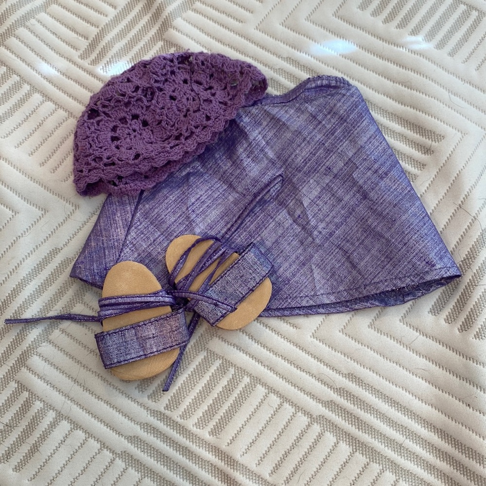 American girl, doll, purple, matching skirt and shoes with purple lace hat.